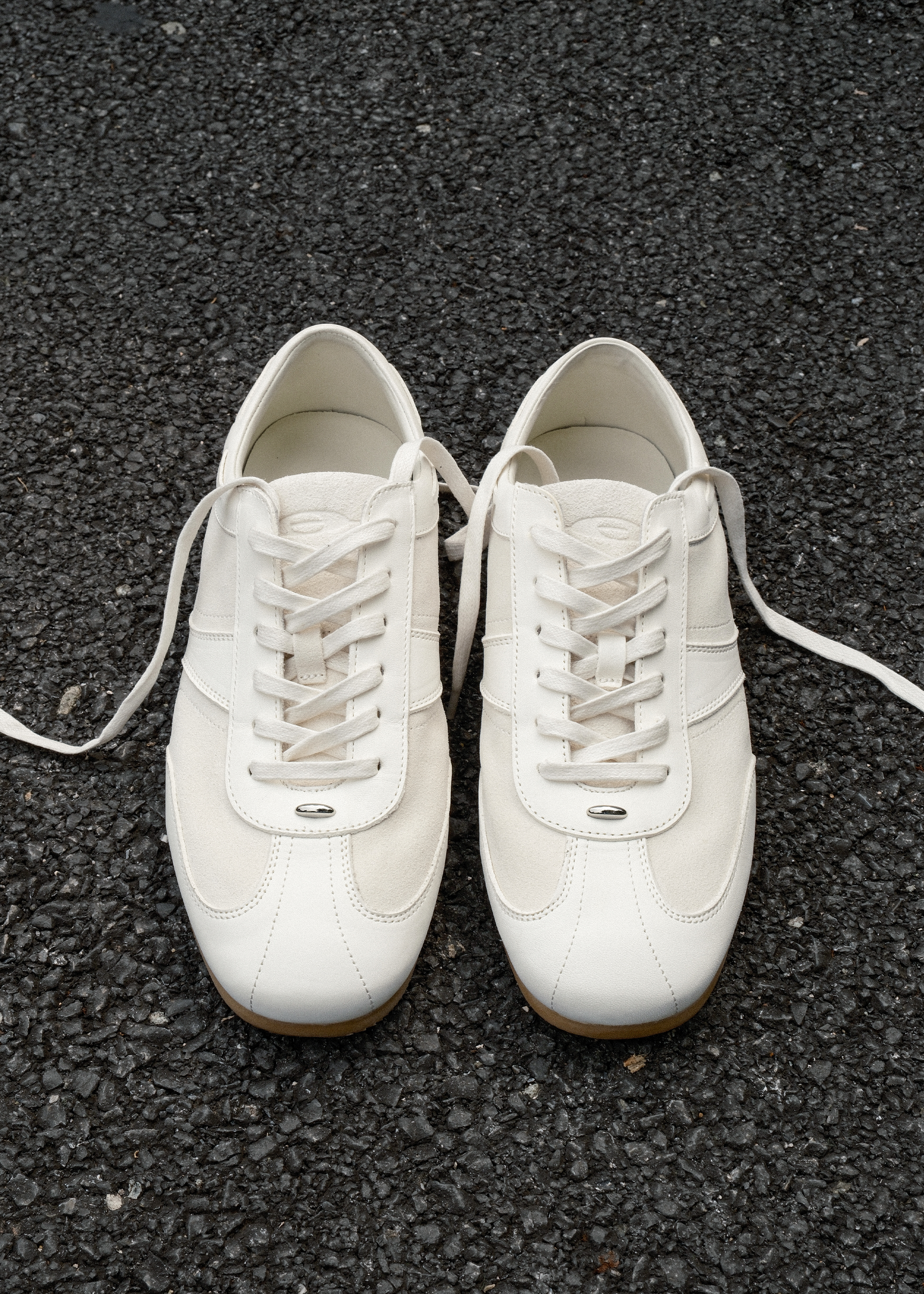 White leather sneakers metal detail close-up
