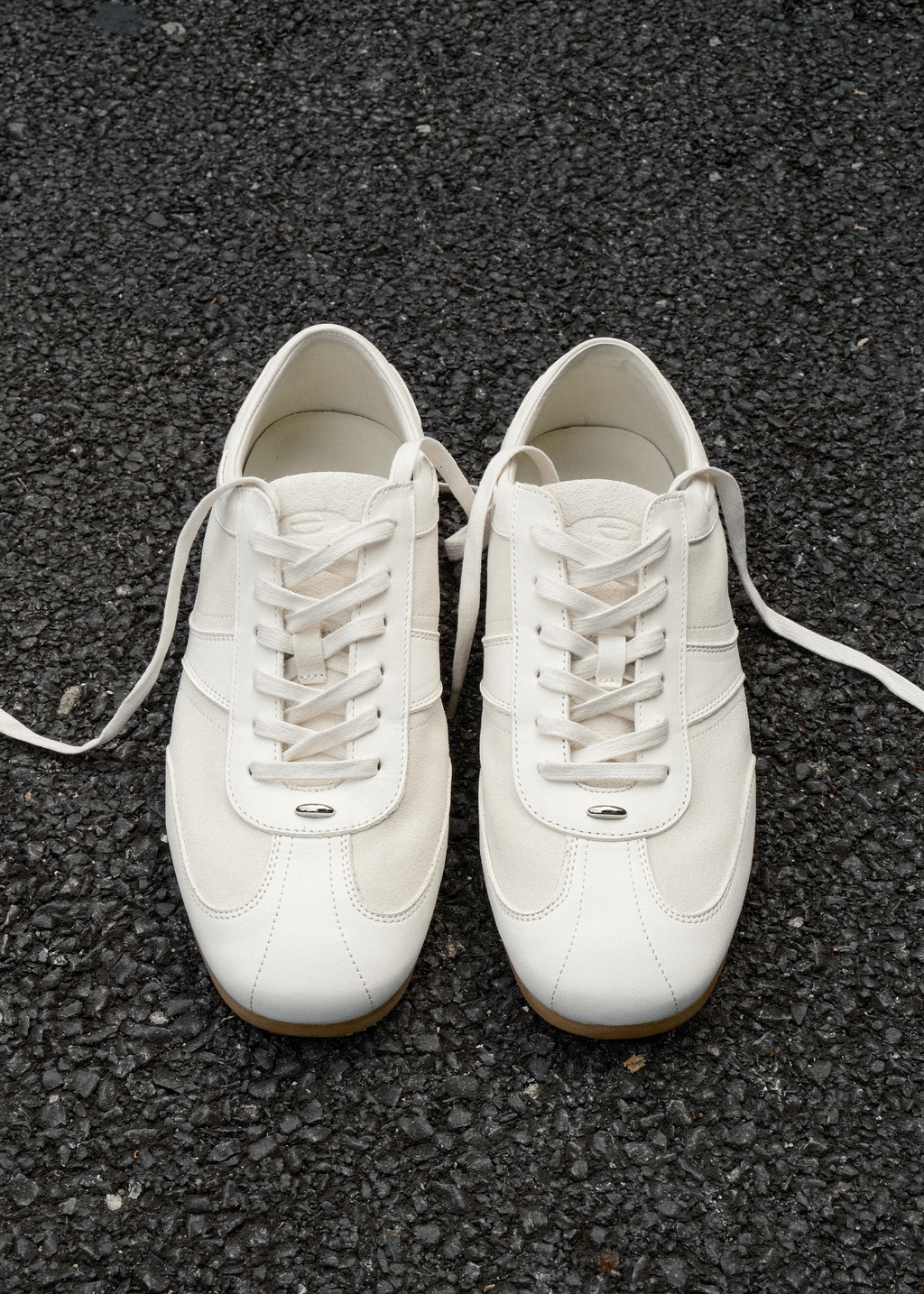 White leather sneakers metal detail close-up