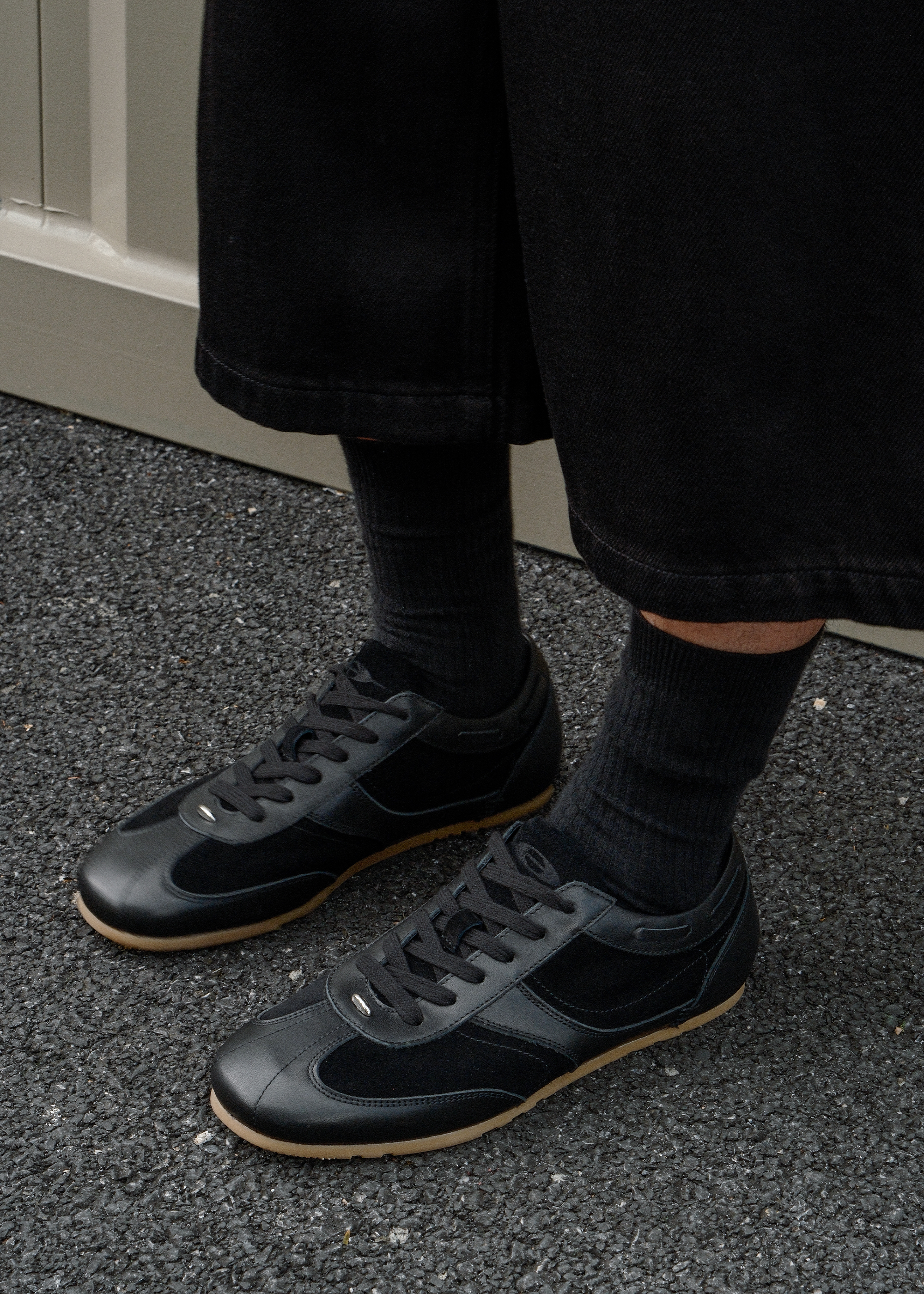 Black leather sneakers metal detail close-up