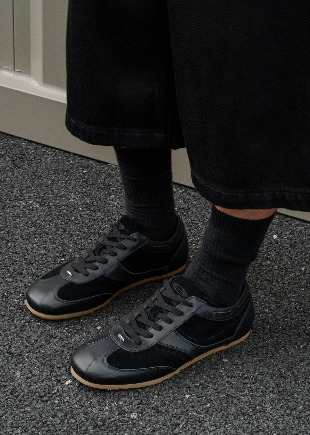 Black leather sneakers metal detail close-up