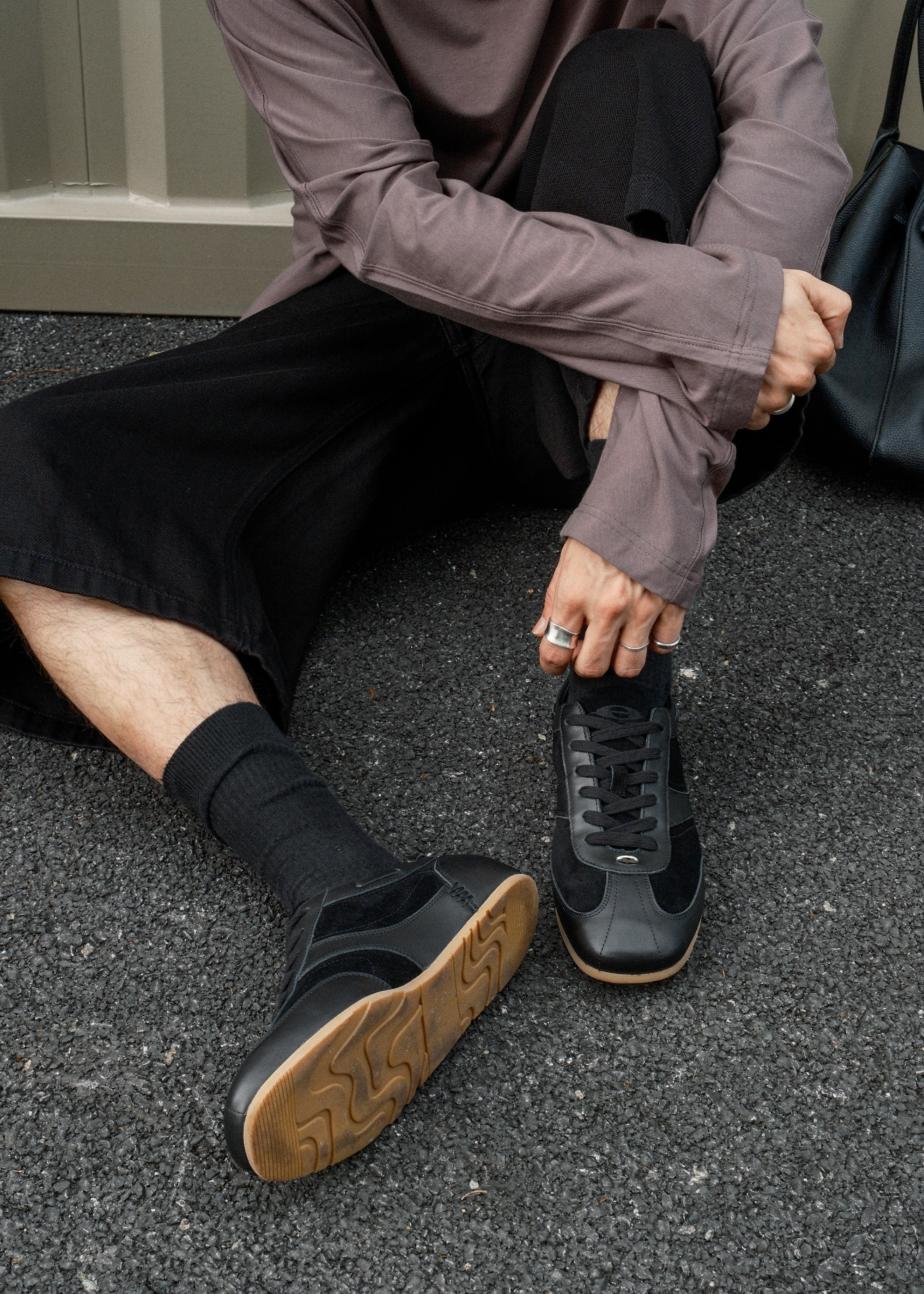 Metal-embellished black sneakers side profile